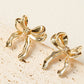 Boucles d'oreilles en forme de noeud avec ruban élégant en or