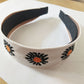 Bandeau à gros nœud en tricot avec marguerite