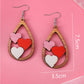 Boucles d'oreilles gouttes d'eau avec insertion de 3 coeurs pour la Saint-Valentin