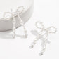 Pendants d'oreilles en forme de nœud papillon avec perles blanches