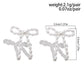 Pendants d'oreilles en forme de nœud papillon avec perles blanches