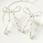 Pendants d'oreilles en forme de nœud papillon avec perles blanches
