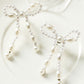 Pendants d'oreilles en forme de nœud papillon avec perles blanches