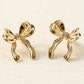 Boucles d'oreilles en forme de noeud avec ruban élégant en or