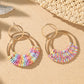 Boucles d'oreilles pendantes en raphia tissé rose bohème