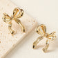 Boucles d'oreilles en forme de noeud avec ruban élégant en or