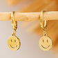 Boucles d'oreilles pendantes en alliage d'or avec visage souriant