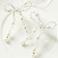 Pendants d'oreilles en forme de nœud papillon avec perles blanches